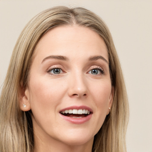 Joyful white young-adult female with long  brown hair and grey eyes