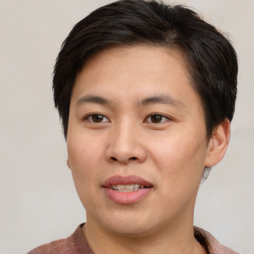 Joyful asian young-adult male with short  brown hair and brown eyes