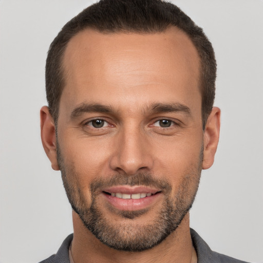 Joyful white young-adult male with short  brown hair and brown eyes