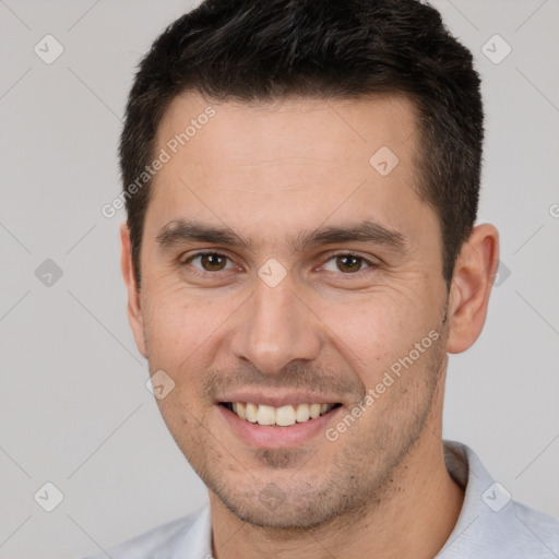 Joyful white young-adult male with short  brown hair and brown eyes