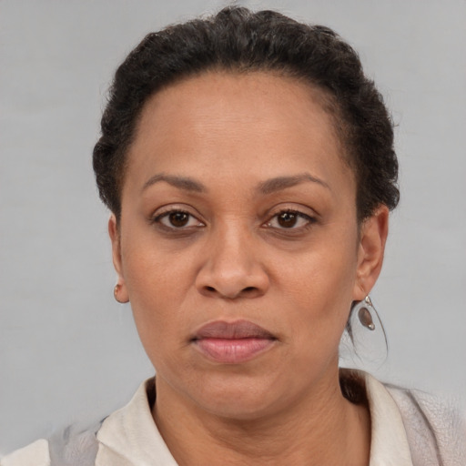 Joyful latino adult female with short  brown hair and brown eyes
