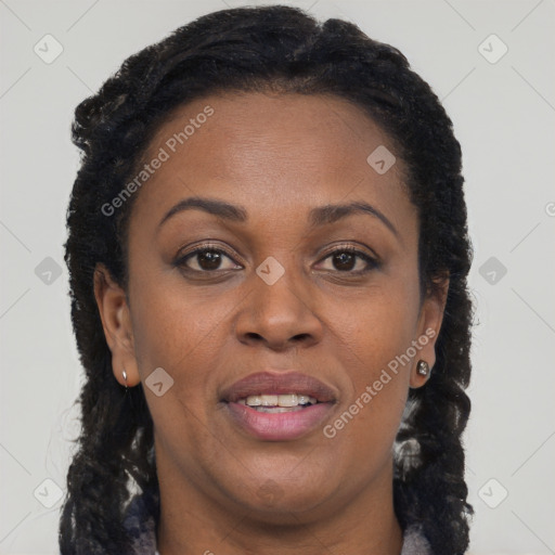 Joyful black adult female with long  brown hair and brown eyes