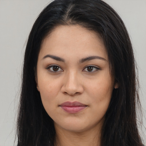 Joyful latino young-adult female with long  brown hair and brown eyes