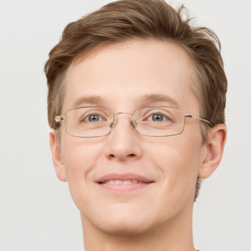 Joyful white adult male with short  brown hair and green eyes