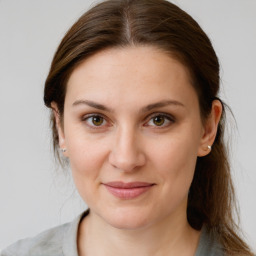 Joyful white young-adult female with medium  brown hair and grey eyes