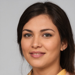 Joyful white young-adult female with medium  brown hair and brown eyes