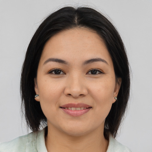 Joyful asian young-adult female with medium  brown hair and brown eyes