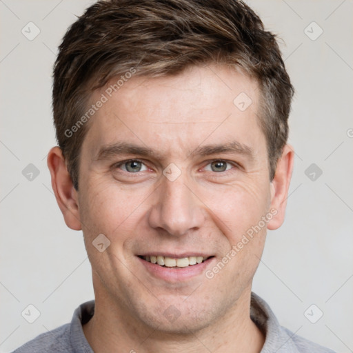 Joyful white adult male with short  brown hair and grey eyes