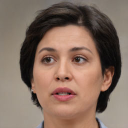 Joyful white adult female with medium  brown hair and brown eyes