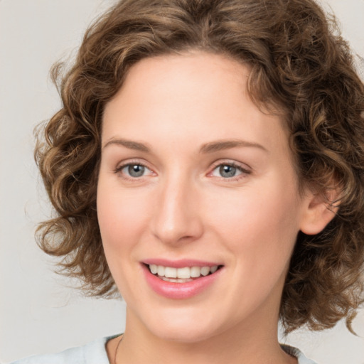 Joyful white young-adult female with medium  brown hair and green eyes