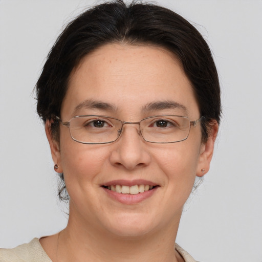 Joyful white adult female with medium  brown hair and brown eyes