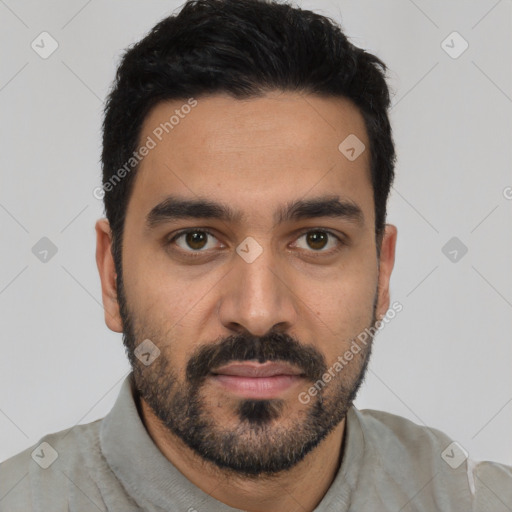 Joyful latino young-adult male with short  black hair and brown eyes