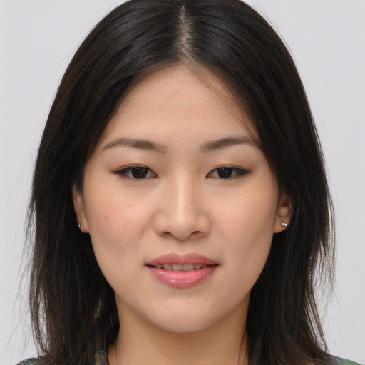 Joyful asian young-adult female with long  brown hair and brown eyes