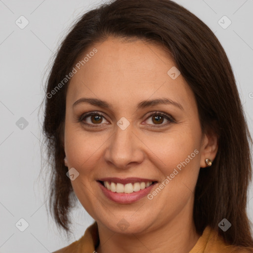 Joyful white adult female with long  brown hair and brown eyes