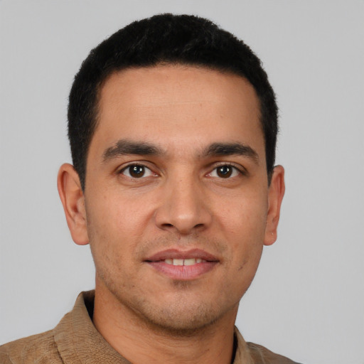 Joyful white young-adult male with short  black hair and brown eyes