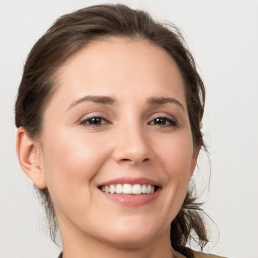 Joyful white young-adult female with medium  brown hair and brown eyes