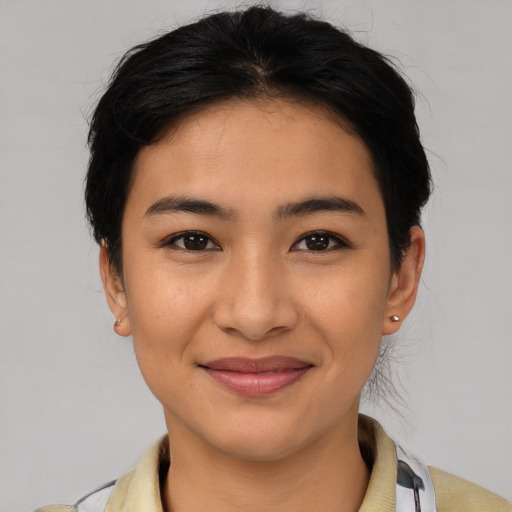 Joyful latino young-adult female with medium  brown hair and brown eyes