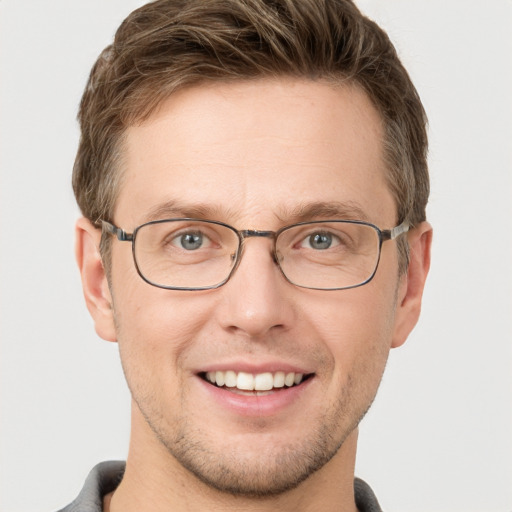 Joyful white adult male with short  brown hair and grey eyes