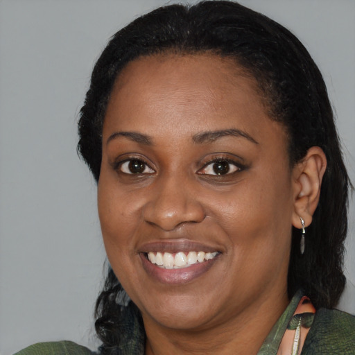 Joyful black adult female with medium  black hair and brown eyes