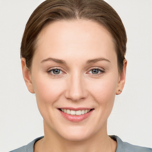 Joyful white young-adult female with short  brown hair and grey eyes