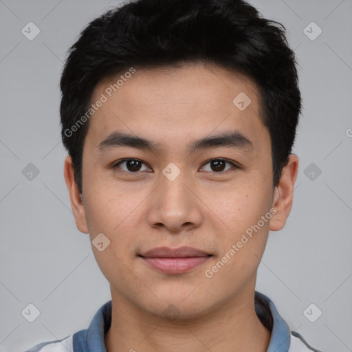 Joyful asian young-adult male with short  black hair and brown eyes