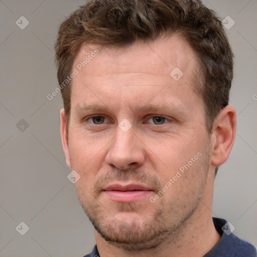 Joyful white adult male with short  brown hair and grey eyes