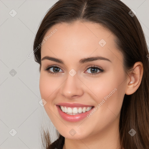 Joyful white young-adult female with long  brown hair and brown eyes