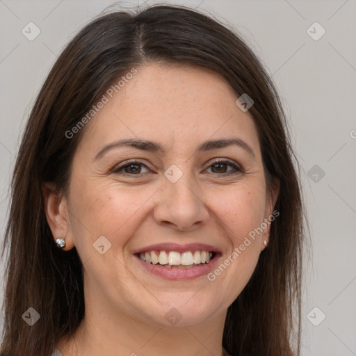 Joyful white adult female with long  brown hair and brown eyes