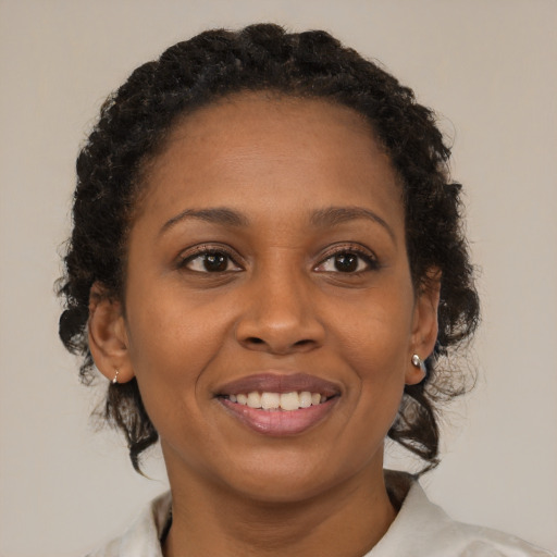 Joyful black young-adult female with medium  brown hair and brown eyes