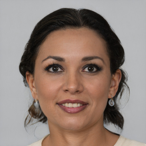 Joyful latino young-adult female with medium  brown hair and brown eyes