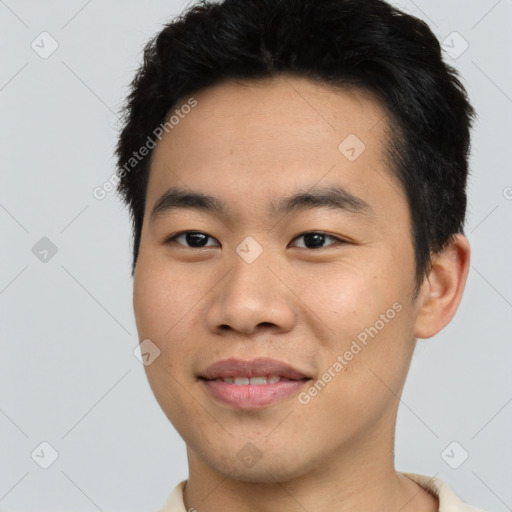 Joyful asian young-adult male with short  black hair and brown eyes