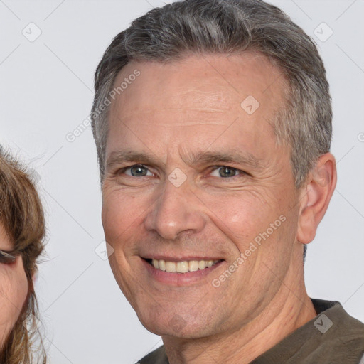 Joyful white middle-aged male with short  brown hair and brown eyes