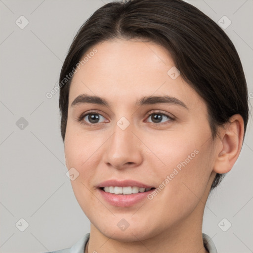 Joyful white young-adult female with short  brown hair and brown eyes