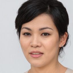 Joyful asian young-adult female with medium  black hair and brown eyes