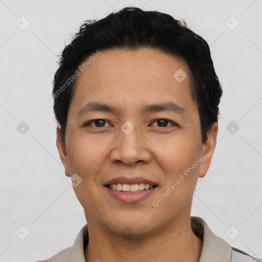 Joyful asian young-adult male with short  black hair and brown eyes