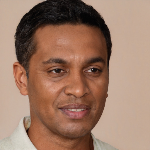 Joyful black young-adult male with short  brown hair and brown eyes