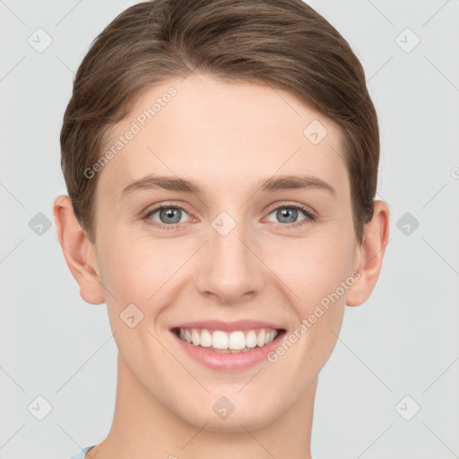 Joyful white young-adult female with short  brown hair and grey eyes