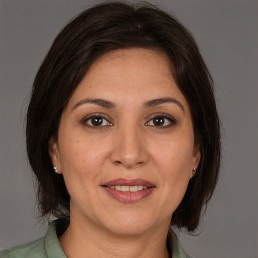 Joyful white adult female with medium  brown hair and brown eyes