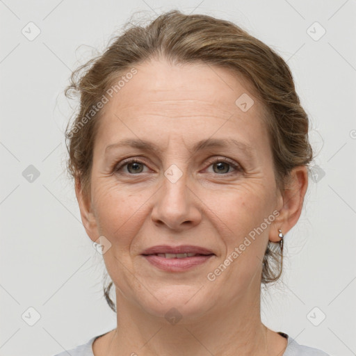 Joyful white adult female with medium  brown hair and grey eyes