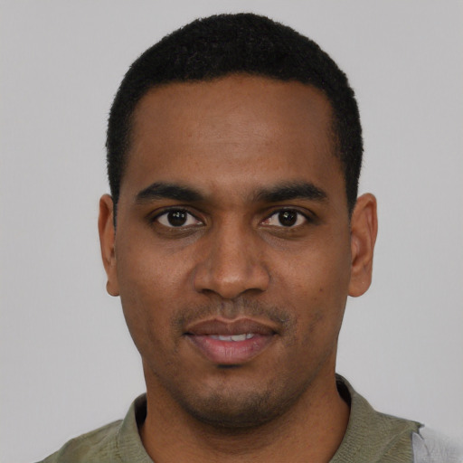 Joyful black young-adult male with short  black hair and brown eyes