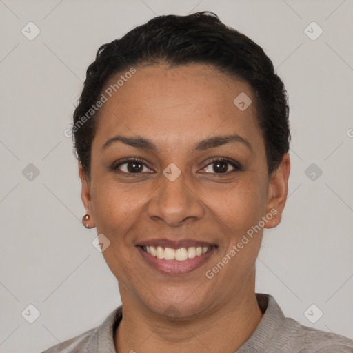 Joyful latino young-adult female with short  black hair and brown eyes