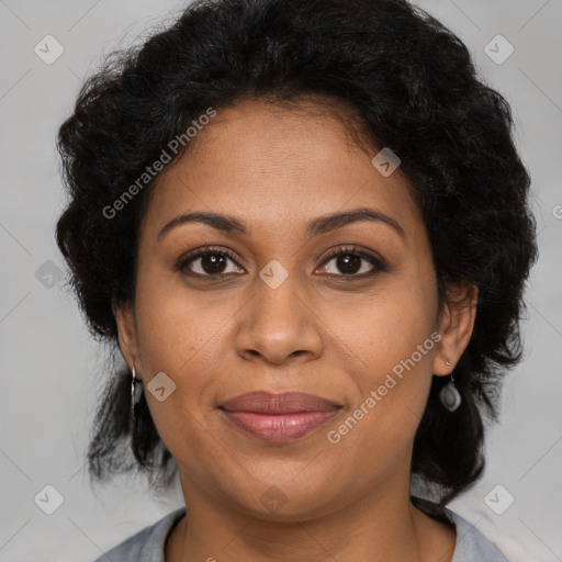 Joyful black adult female with medium  brown hair and brown eyes