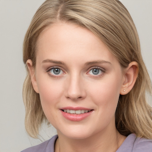 Joyful white young-adult female with medium  brown hair and blue eyes