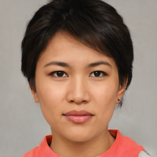 Joyful asian young-adult female with short  brown hair and brown eyes