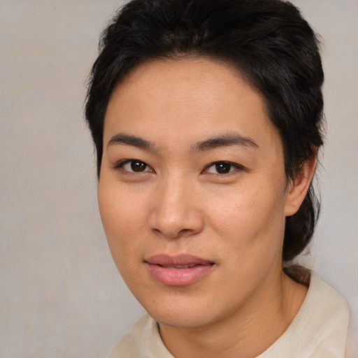 Joyful asian young-adult female with medium  brown hair and brown eyes