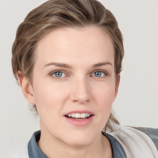 Joyful white young-adult female with medium  brown hair and grey eyes