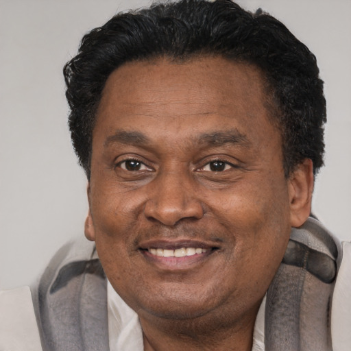 Joyful black adult male with short  brown hair and brown eyes