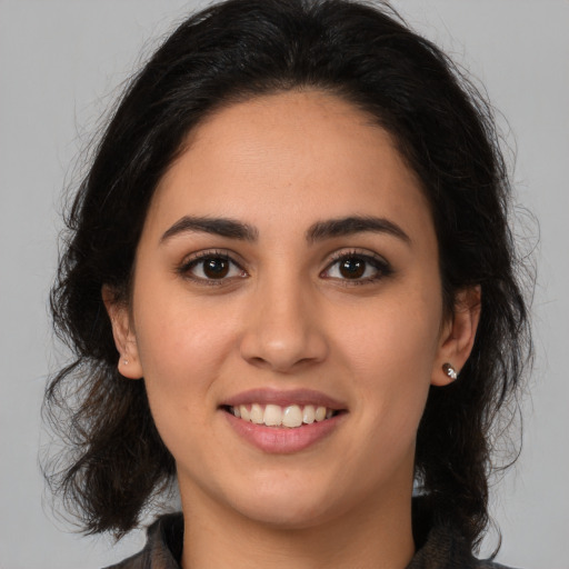 Joyful latino young-adult female with medium  brown hair and brown eyes