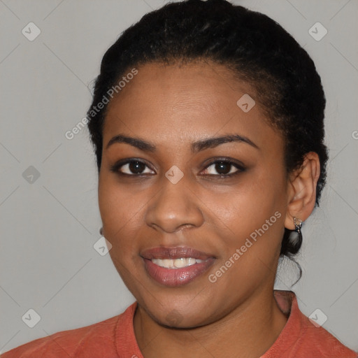 Joyful black young-adult female with short  black hair and brown eyes