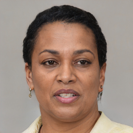 Joyful latino adult female with short  brown hair and brown eyes